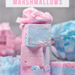 A stack of cotton candy marshmallows with pink cotton candy on top