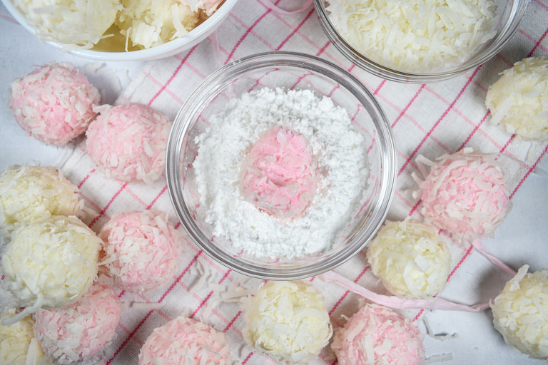 Bunny tail truffles on a pink and white surface