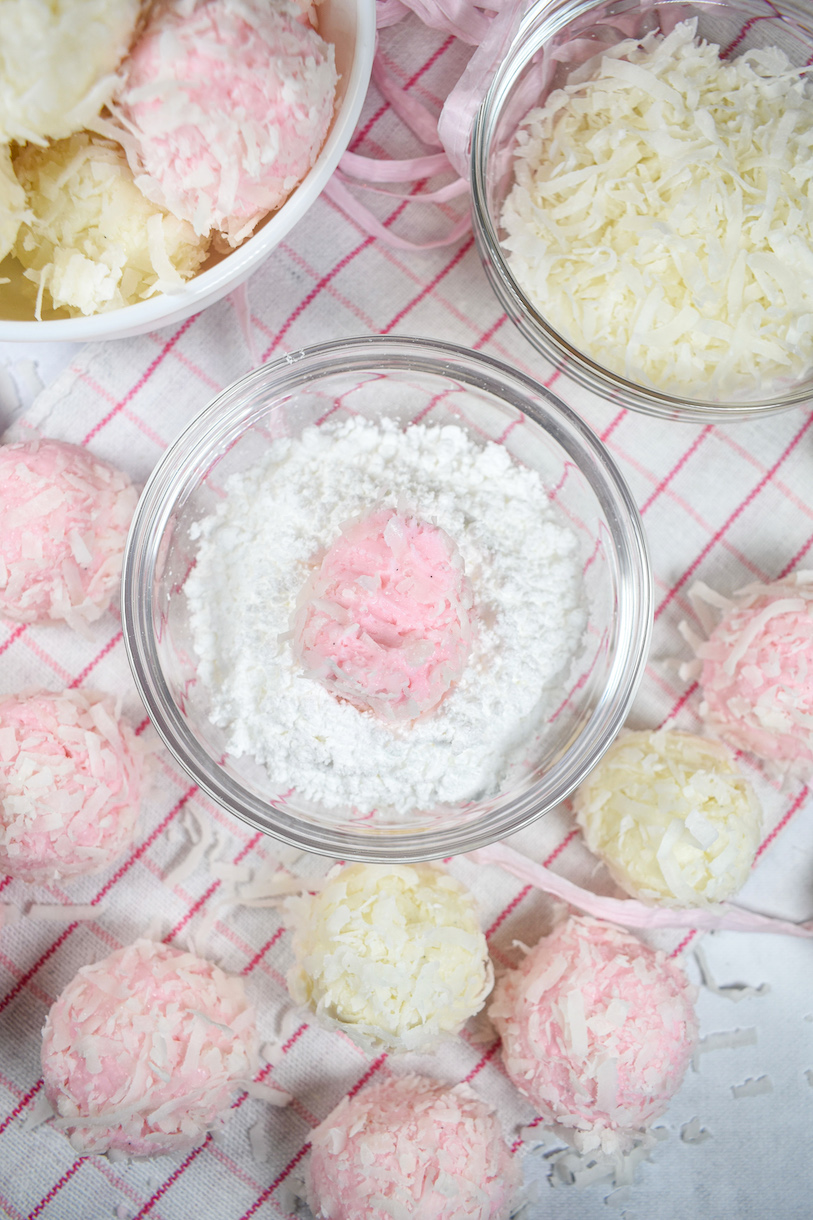A dish of confectioner's sugar and a pink Easter truffle
