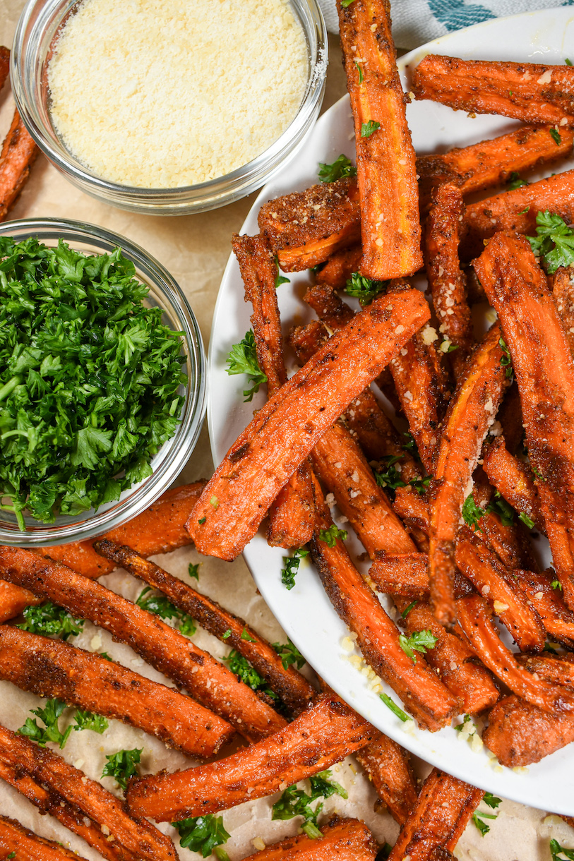 Carrot fries alongside bowls of parsley and cheese