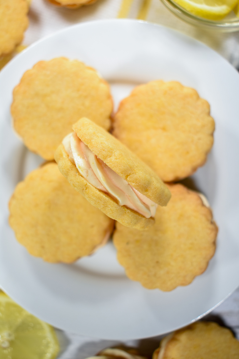 A plate of lemon biscuits with lemon creme filling