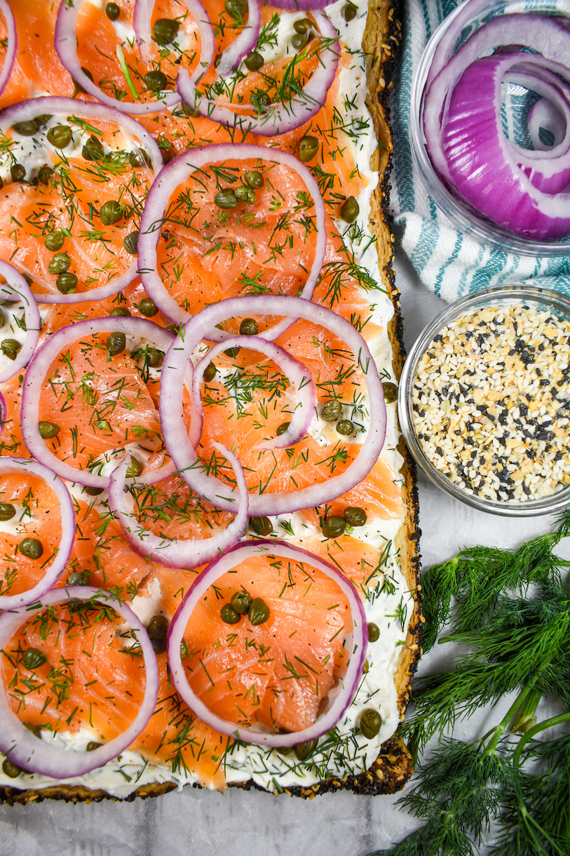 a puff pastry tart with smoked salmon, cream cheese, red onion, and dill