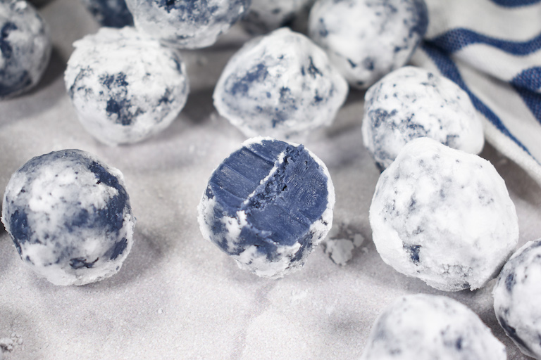 An Earl Grey chocolate truffle with a bite removed