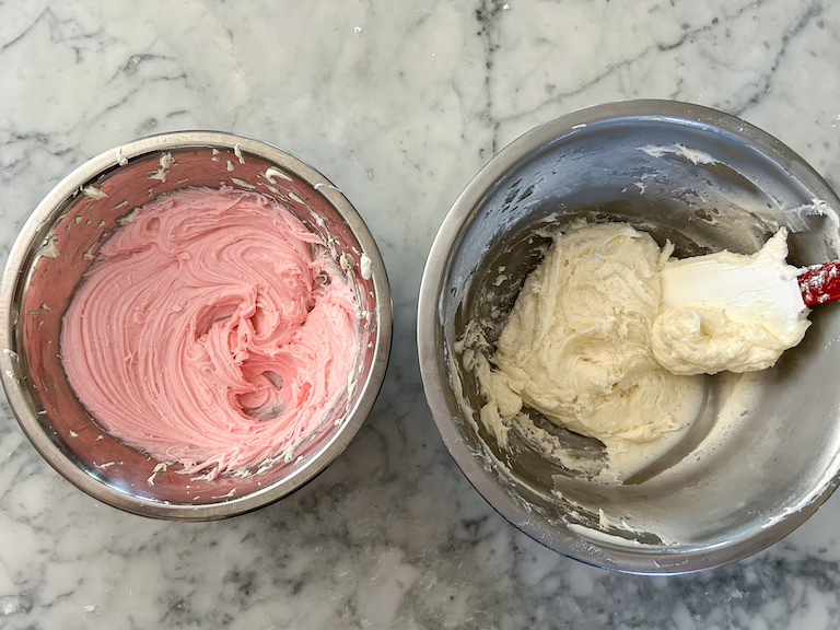 Bowls of pink and white cream cheese truffle dough