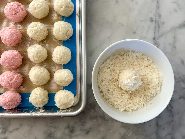 A bowl of shredded coconut and a white truffle