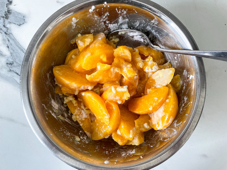 Peach filling ingredients in a metal bowl