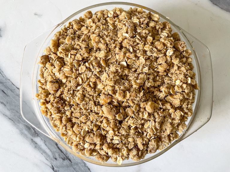 Peach crisp in a baking dish before baking