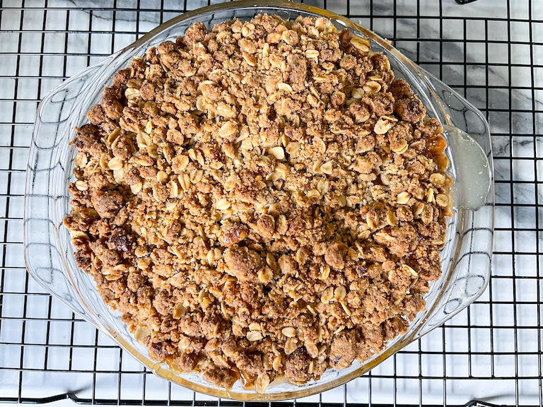 Peach crisp cooling on a wire rack
