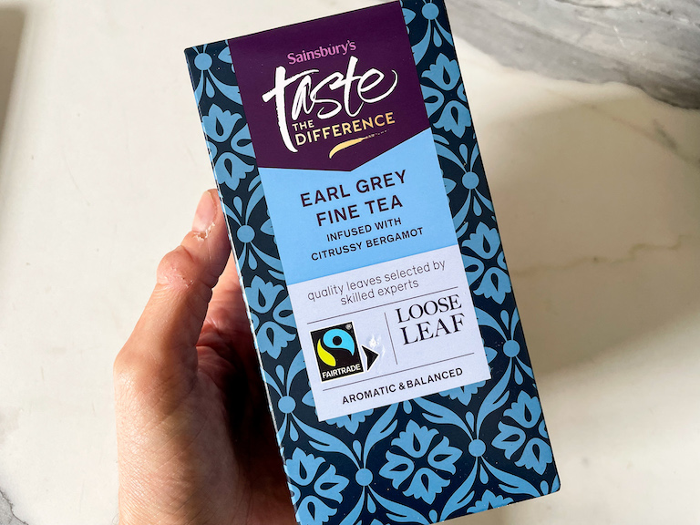 Hand holding a box of Earl Grey tea