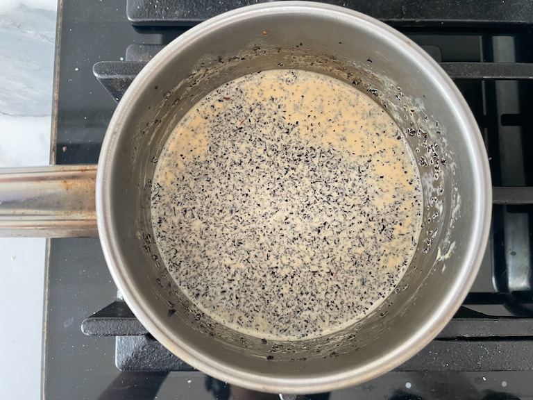 Earl Grey tea and cream in a small pan on the stovetop