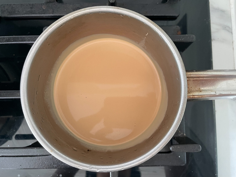 A small pan of Earl Grey infused whipping cream on the stovetop