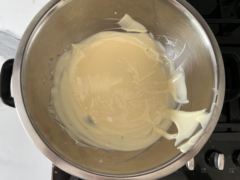 Bowl of melted white chocolate on the stovetop