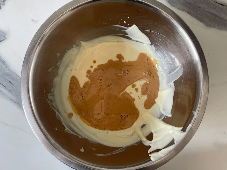 Pouring Earl Grey infused cream into melted white chocolate