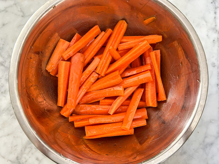 bowl of carrot sticks drizzled with olive oil