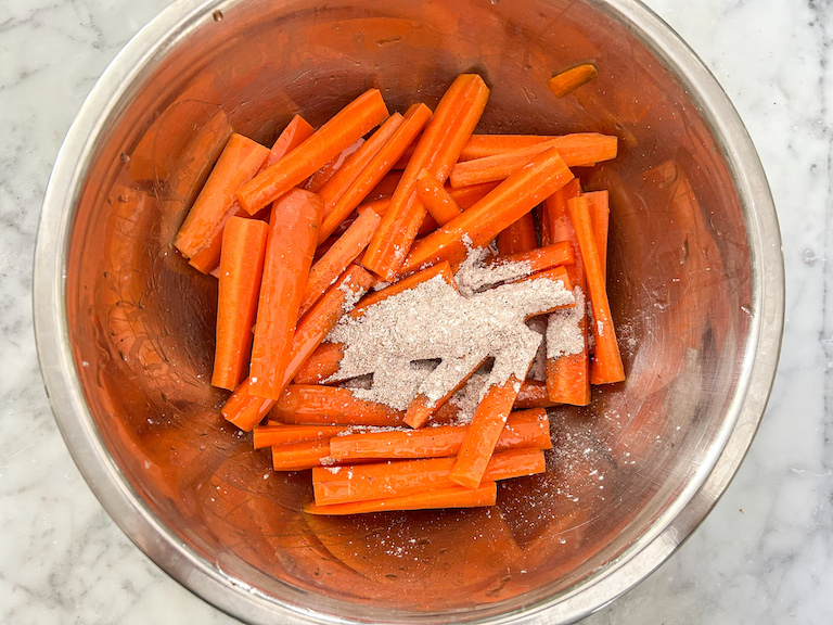 Carrot sticks and spices in a bowl