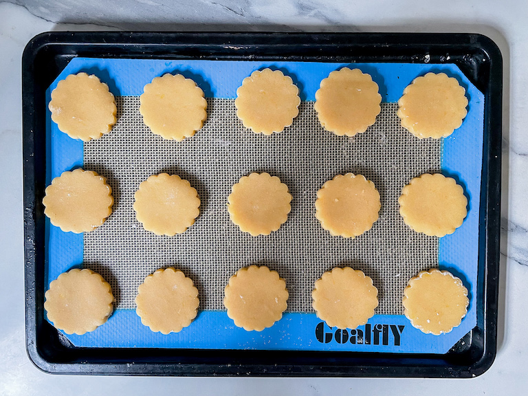 Discs of cookie dough arranged on a tray