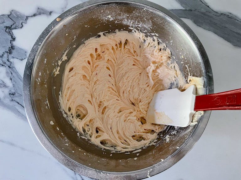 Lemon cream filling in a bowl with a spatula