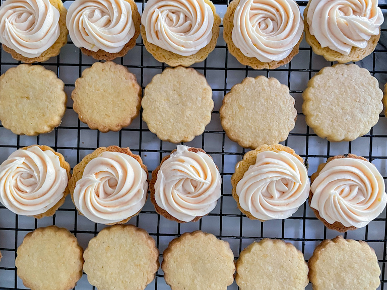 Swirls of lemon filling piped over scalloped edge biscuits