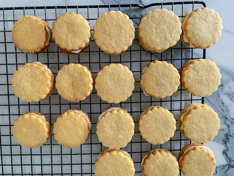 Lemon sandwich cookies on a wire rack