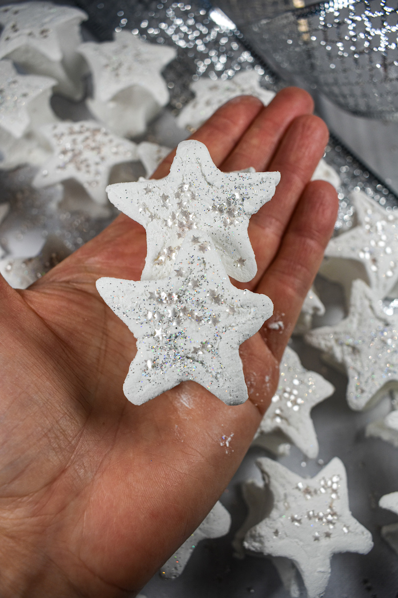 Hand holding two star shaped marshmallows