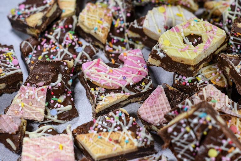 Pieces of biscuit bark on a white surface