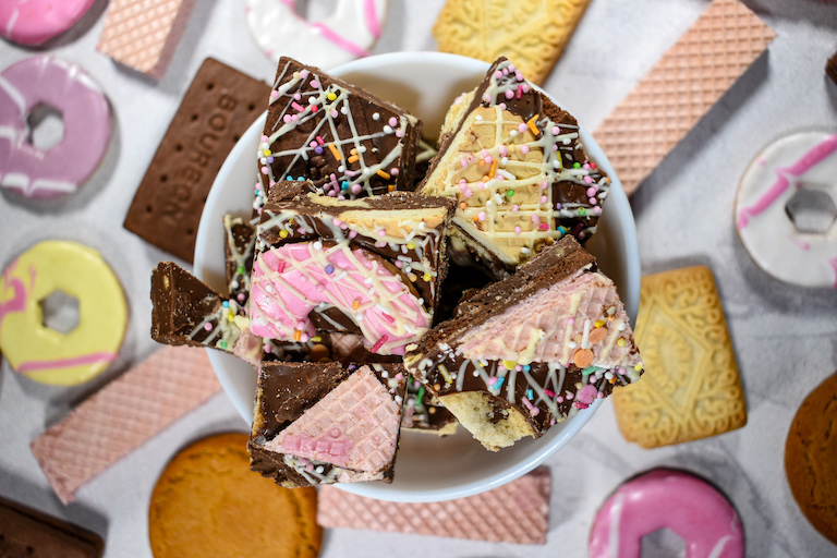 A bowl oc chocolate bark made with British biscuits, melted chocolate, and sprinkles