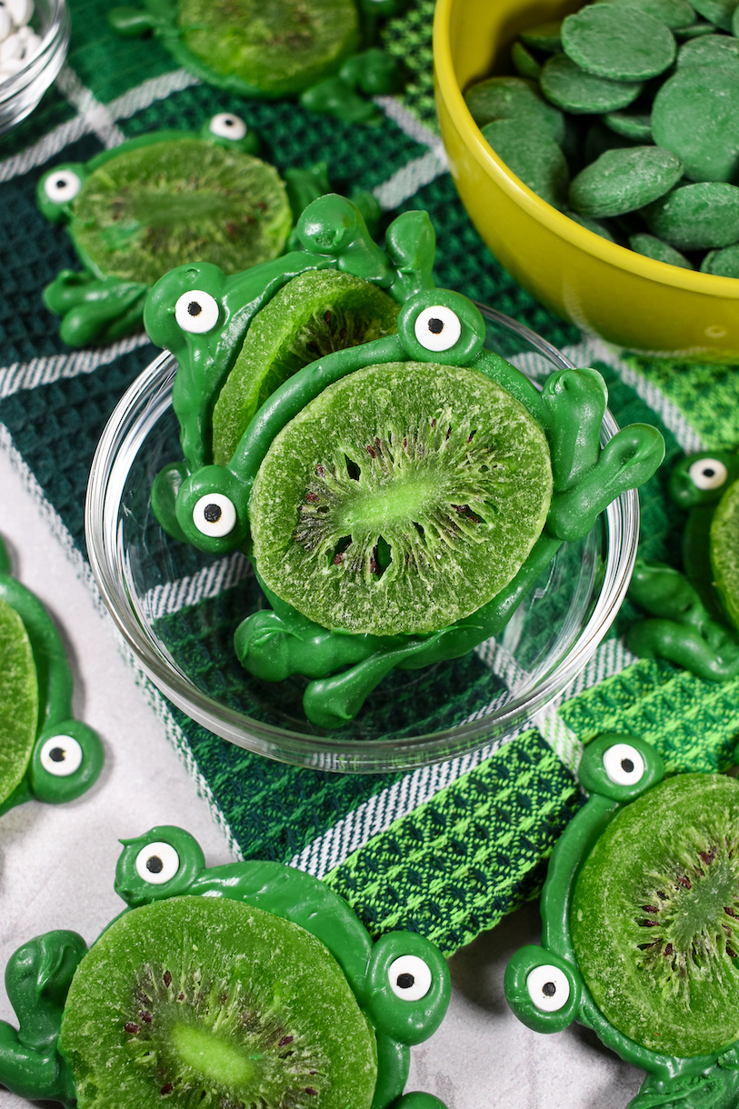 Kiwi frogs in a dish on a plaid green towel