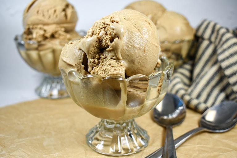 A dish of coffee ice cream and two spoons