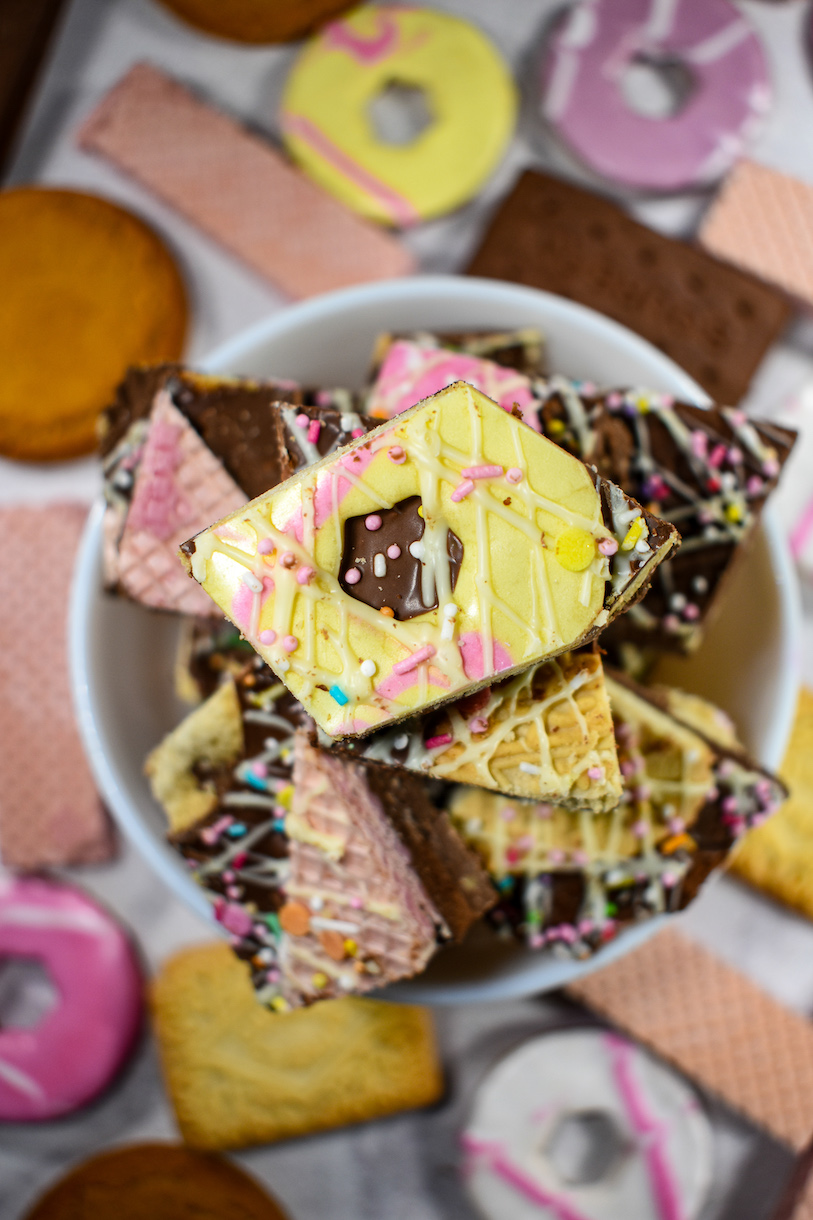 A bowl of biscuit bark surrounded by assorted British biscuits