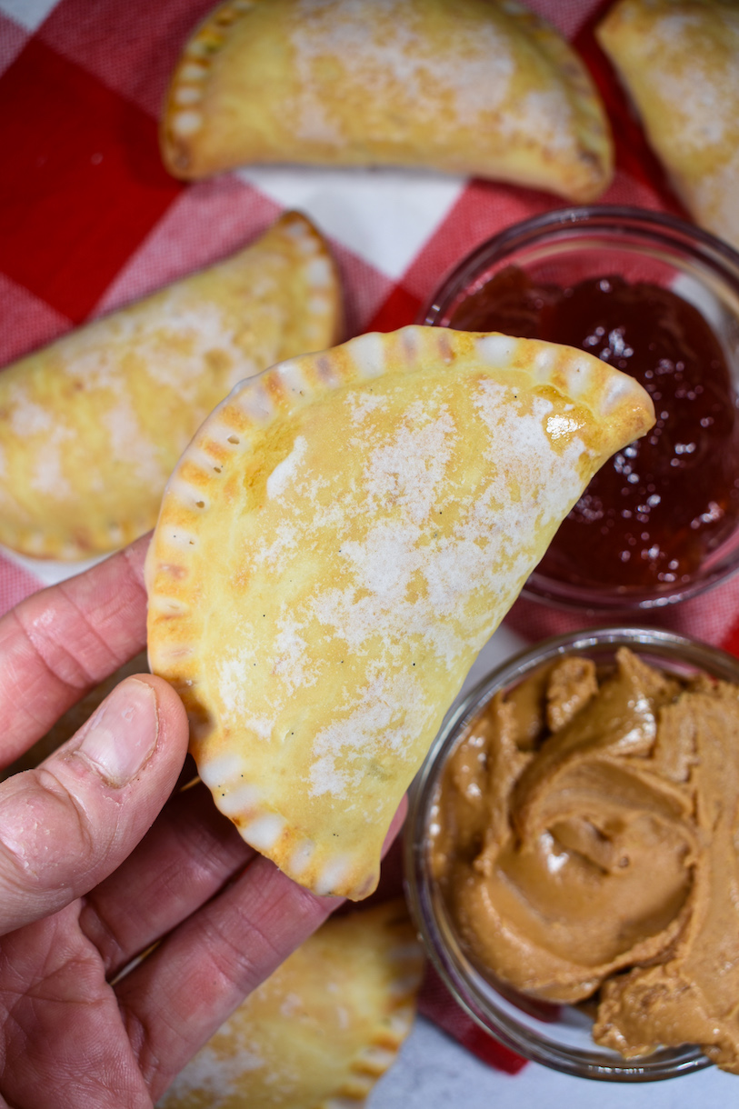 Hand holding a peanut butter and jelly hand pie