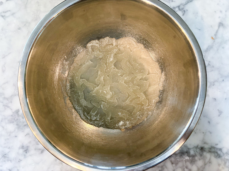 Gelatin and water in a metal bowl