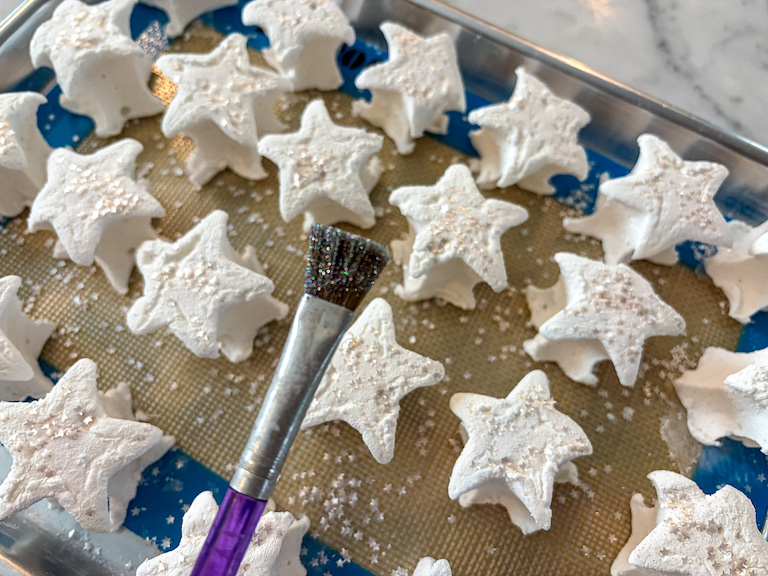 A paintbrush covered in edible glitter