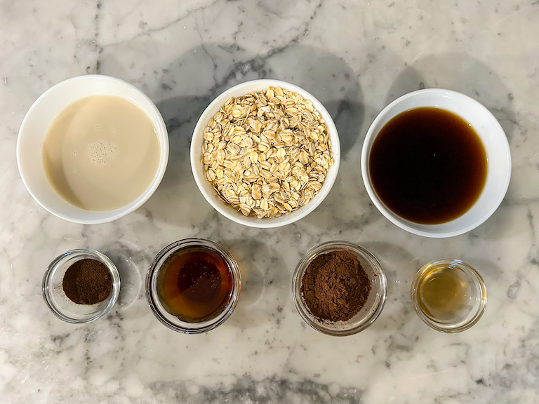Ingredients for making overnight tiramisu oats arranged on a marble surface