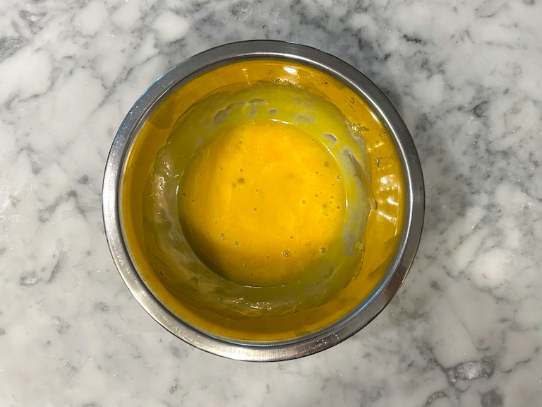 Beaten egg yolks in a bowl