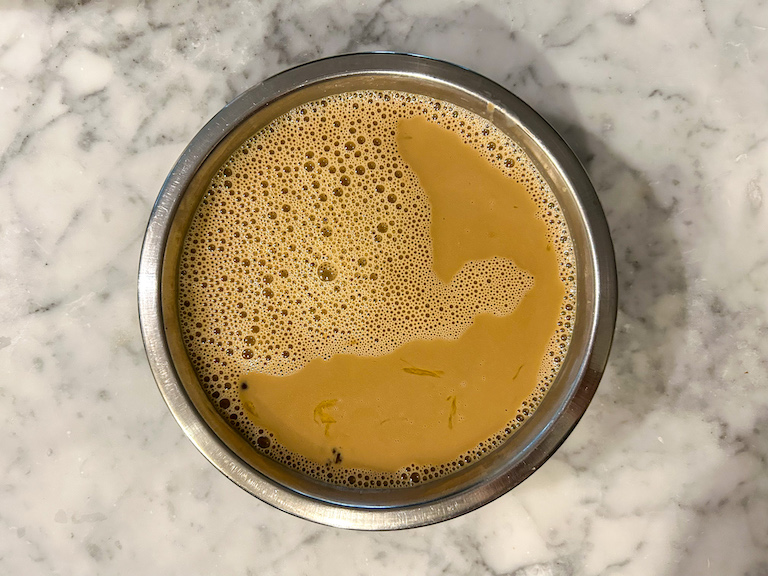 Coffee ice cream base in a metal bowl
