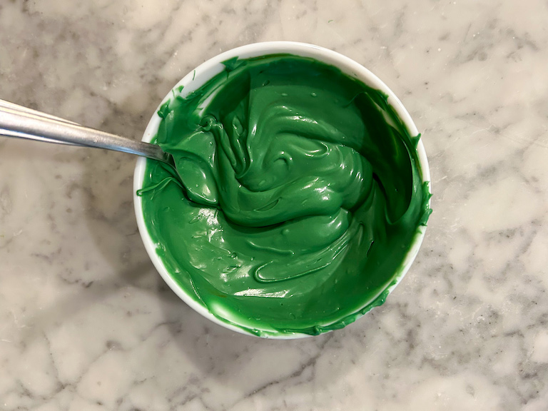 A bowl of melted green chocolate