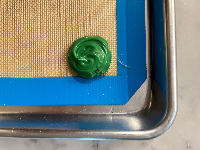 A dollop of green chocolate on a silicone mat