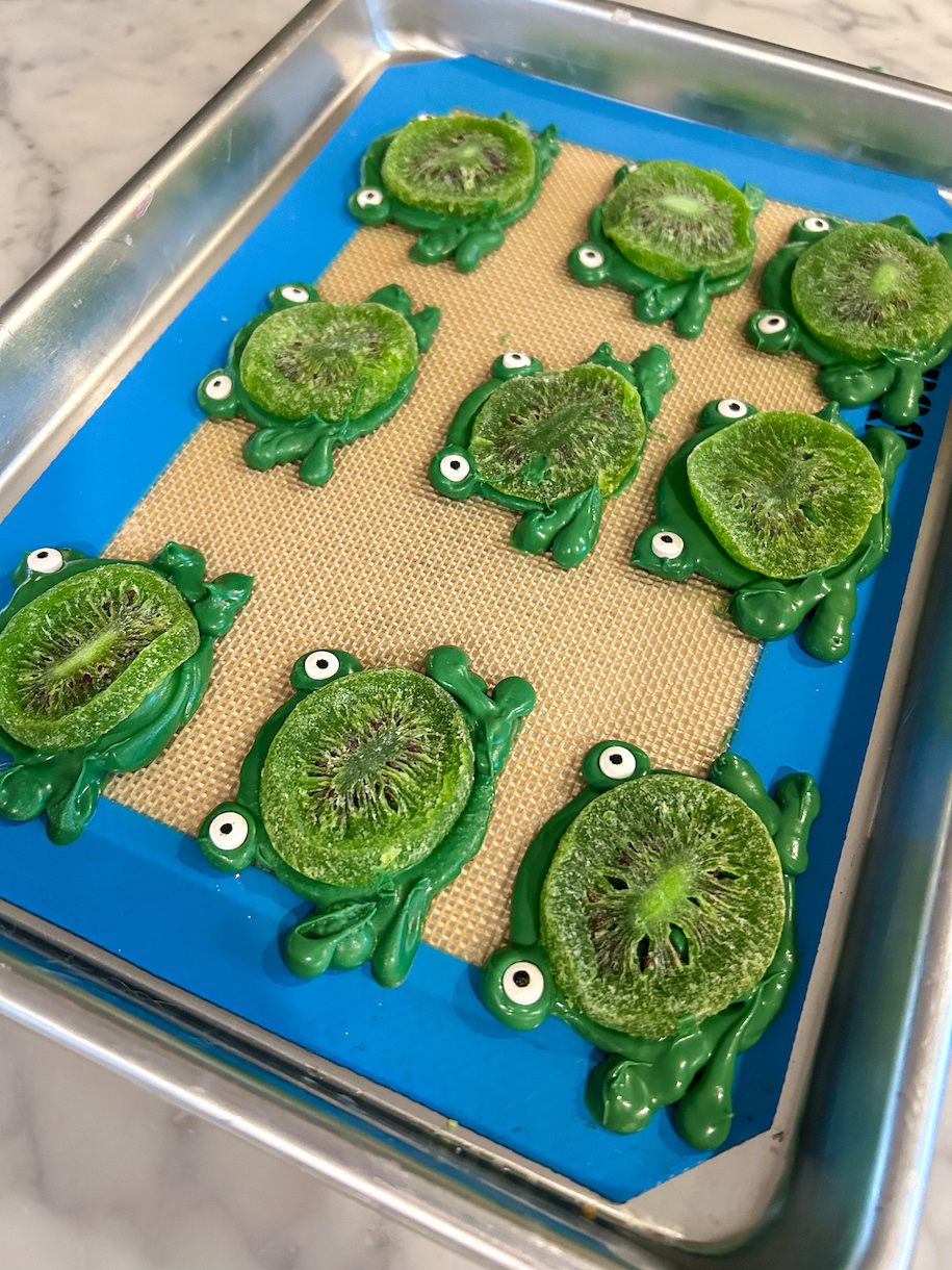 A tray of chocolate frogs with kiwi