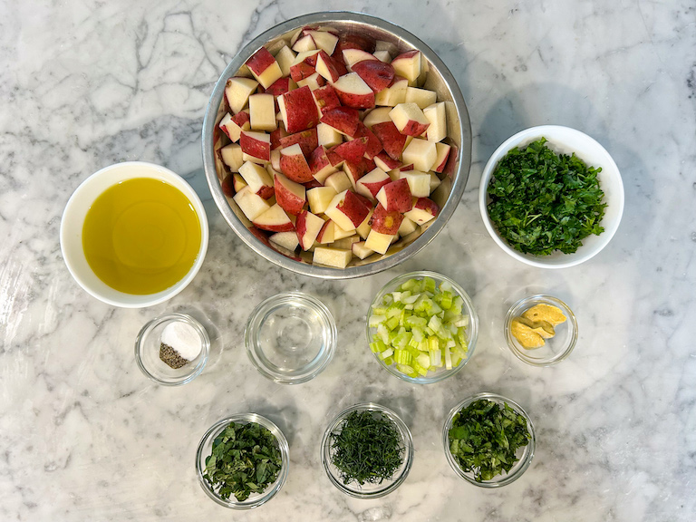 No mayo red potato salad ingredients on a marble surface