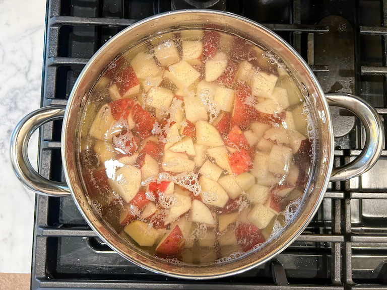 Potatoes boiling in a stock pot on the stovetop