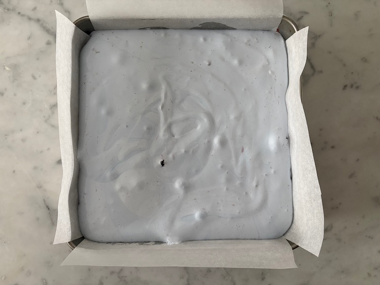 Tin of blueberry marshmallows on a marble surface