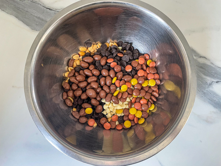 Peanut butter chocolate trail mix ingredients in a bowl