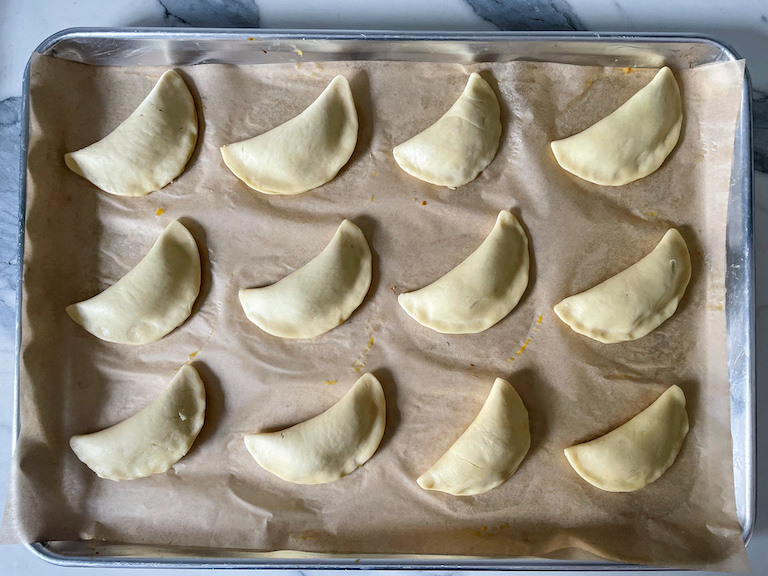 Hand pies on a tray before baking