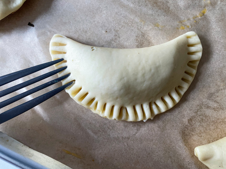 Fork crimping the edges of a hand pie