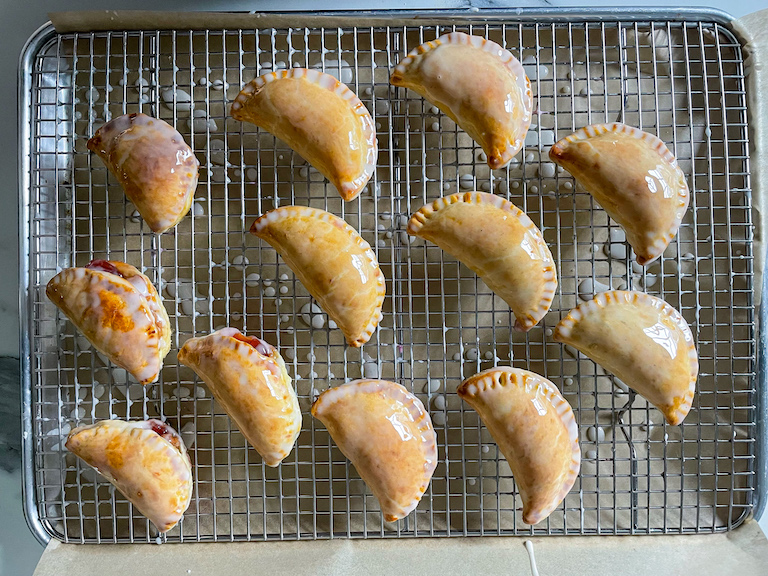 Glazed pb&j hand pies on a wire rack