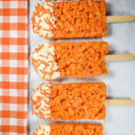 row of creamsicle krispie treat popsicles