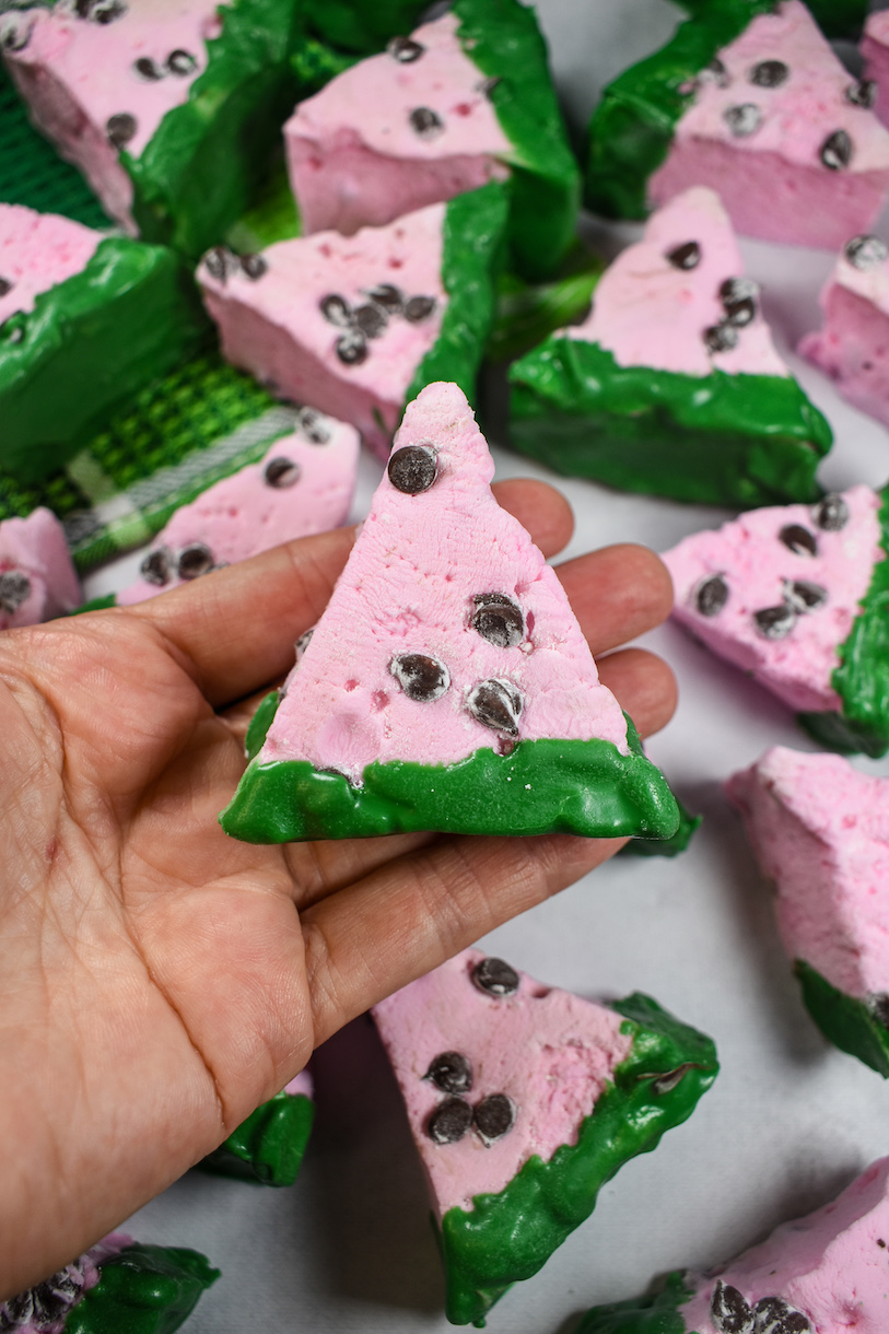 Hand holding a watermelon marshmallow