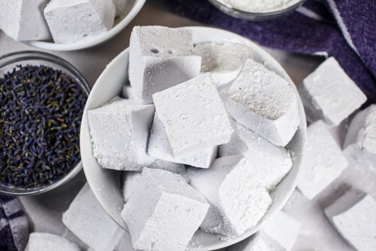 A bowl of lavender vanilla marshmallows and a dish of dried lavender