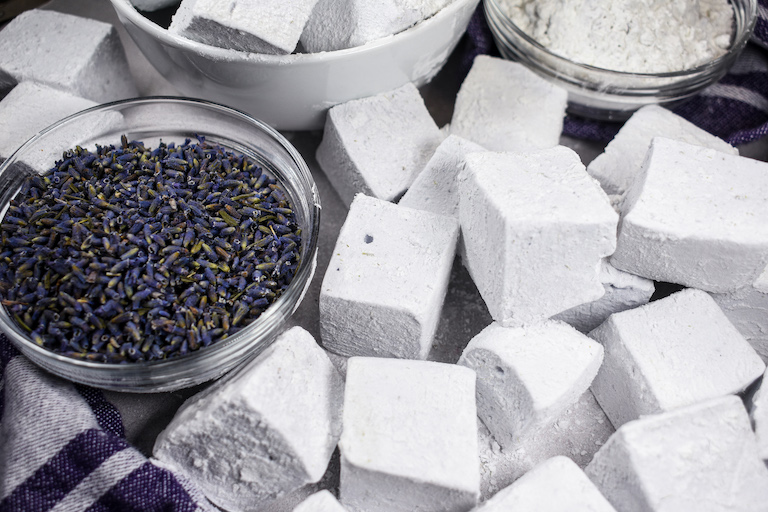 A dish of dried lavender surrounded by homemade marshmallows