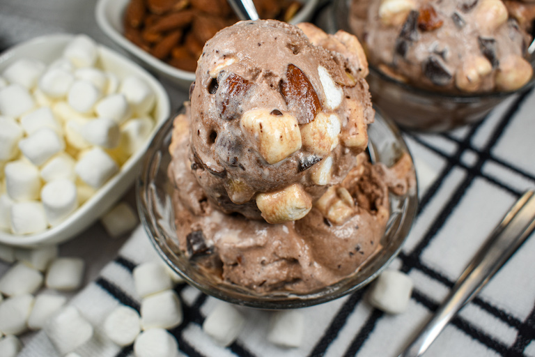 A dish of homemade rocky road ice cream on a plaid towel
